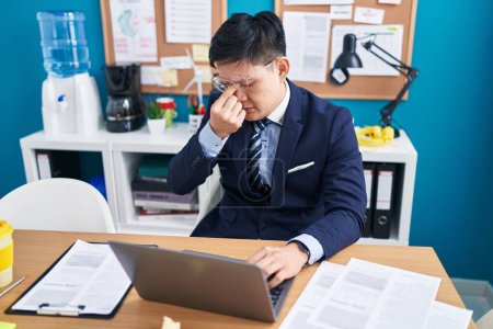 Photo for Young chinese man business worker stressed using laptop at office - Royalty Free Image