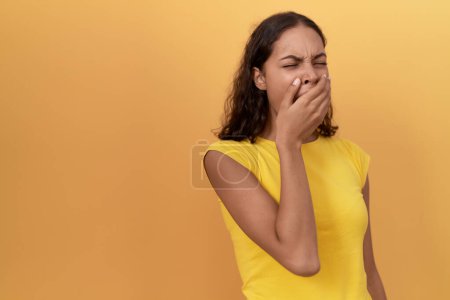 Photo for Young african american woman yawning over isolated yellow background - Royalty Free Image