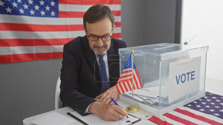 Middle-aged man voting in an american election indoors with a us flag backdrop.