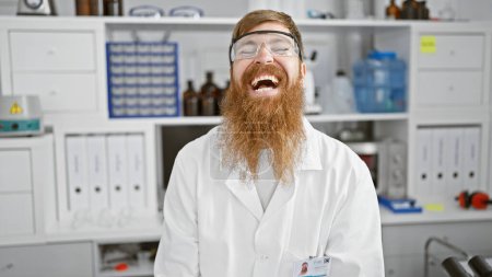 Photo for Smiling young redhead scientist, full of confidence, man in lab sporting secure glasses - Royalty Free Image