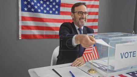 Mature man votes in american election indoors with us flag