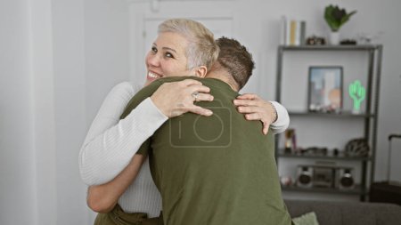 Photo for A woman hugging a man in a cozy living room, showcasing affection, family, and a comfortable home atmosphere. - Royalty Free Image