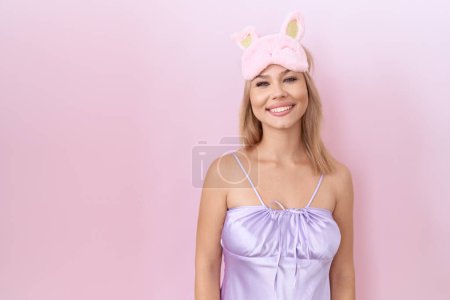 Photo for Young caucasian woman wearing sleep mask and pajama dress with a happy and cool smile on face. lucky person. - Royalty Free Image