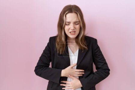 Photo for Young caucasian business woman wearing black jacket with hand on stomach because indigestion, painful illness feeling unwell. ache concept. - Royalty Free Image