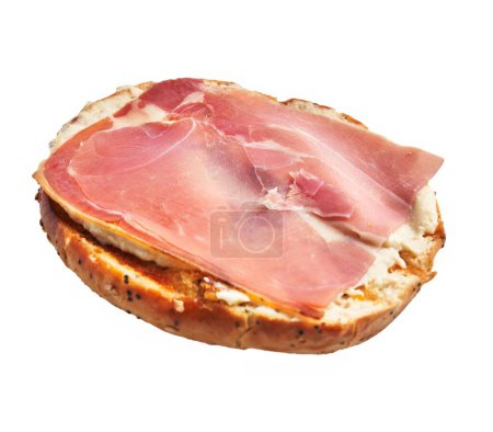 Photo for A sliced bagel topped with cream cheese and delicate prosciutto against a white background. - Royalty Free Image