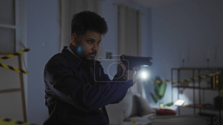 Photo for African man acting as detective with gun in a dimly lit crime scene room, indicating drama and investigation. - Royalty Free Image