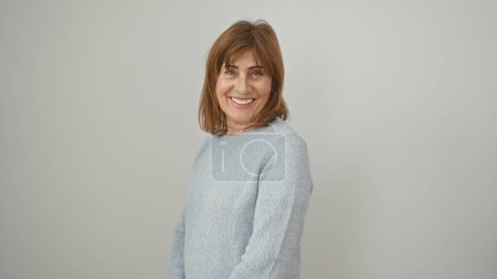 Photo for Portrait of a smiling middle-aged woman with short hair in a casual sweater, against a white background. - Royalty Free Image