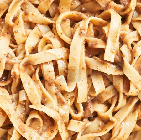 Photo for Close-up of creamy beef stroganoff with fettuccine, seasoning, mushrooms, and sauce in a bowl. - Royalty Free Image