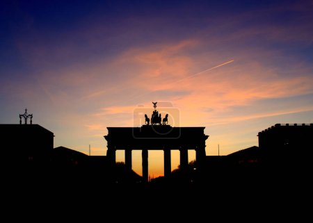 Photo for The Brandenburg gate, symbol of the city of Berlin, silhouette at sunset - Royalty Free Image