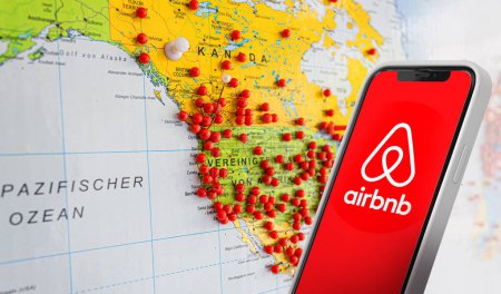 Photo for Vilnius, Lithuania, July 20, 2023:Smartphone with airbnb logo on the background of the world map with stop markers. With copy space for text - Royalty Free Image
