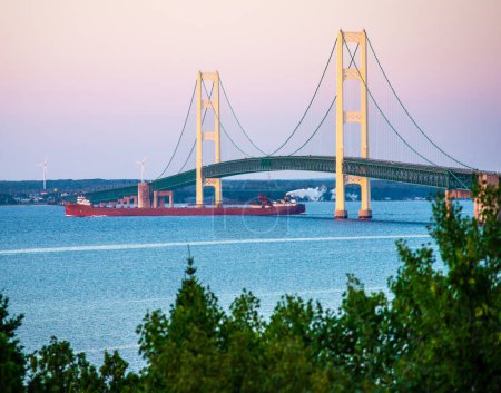 Photo for Mac Bridge view from St.Ignace state park at sunrise with Ship - Royalty Free Image