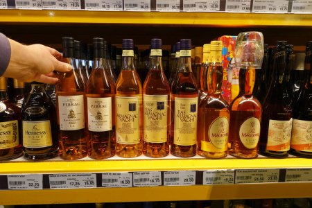 Photo for NETHERLANDS - JANUARY 2022: Various Bottles alcoholic distinctive brands of French Armagnac and Calvados for sale at a wholesaler - Royalty Free Image