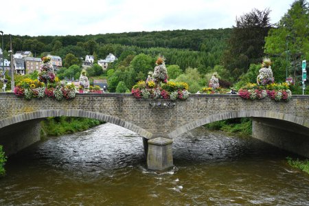 Bridge decorated with large flower arrangements over the Ambleve river neat Trois-Ponts in the Belgian Ardennes