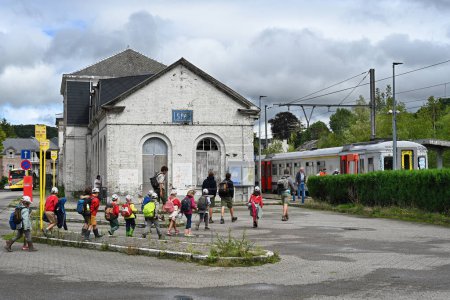 Photo for SPA, WALLONIA, BELGIUM - AUGUST 2023: Group of scouting children walk from the bus stop to a waiting train at the platform of Spa railway station in the Belgian Ardennes - Royalty Free Image