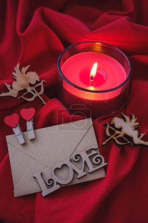 Photo for Valentine's day greeting card with envelope and candle on red background - Royalty Free Image