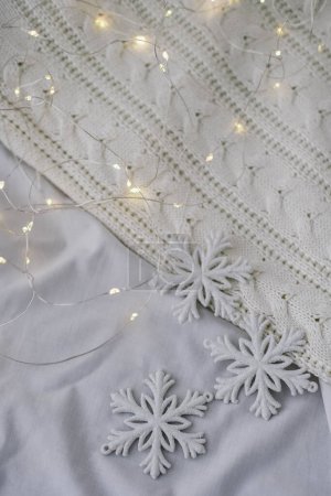 Photo for Christmas decoration with white snowflakes on a white knitted background - Royalty Free Image