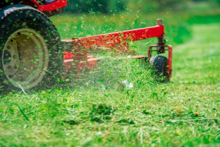 Photo for Lawnmover at work in a meadow - Royalty Free Image