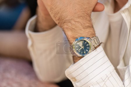 Close-up shot of a wristwatch on a man's hand