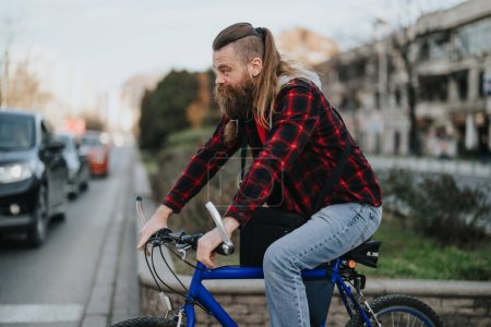 A bearded businessman on a bike in an urban setting, portraying an eco-conscious professional with an active lifestyle.