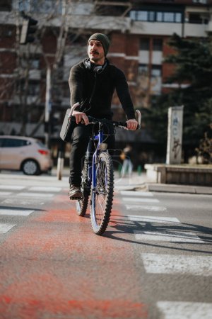 Stylish man on bicycle with headphones crossing the street in urban setting, showcasing active lifestyle and alternative transportation.