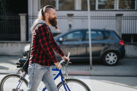 Urban professional man with a bicycle in the city, showcasing eco-friendly commuting and working remotely outdoors.