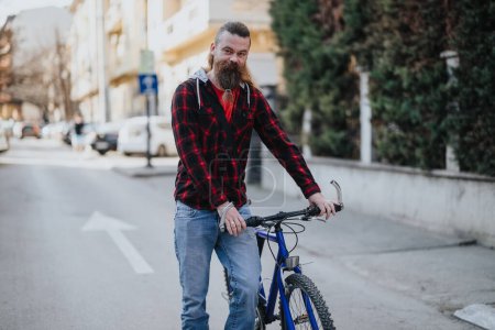 A bearded businessman with a bicycle stands in an urban setting, showcasing sustainable transport and a flexible work lifestyle.