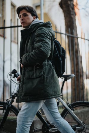 A fashionable young adult preparing for a bike ride in an urban setting during the colder season.