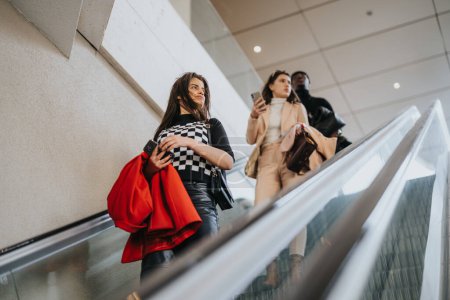 Three young business partners ascending an escalator. The professional setting is enhanced by their focused expressions and smart attire.