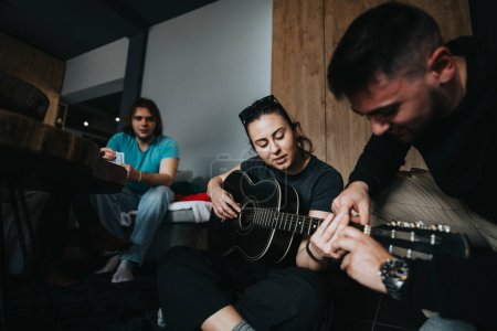 Intimate scene of friends sharing a moment of music and togetherness, playing guitar in a cozy indoor setting