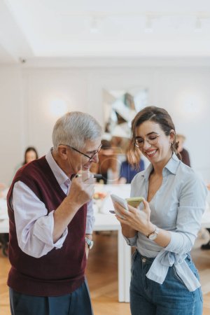 Ein fesselndes Foto, das eine fröhliche Interaktion zwischen den Generationen festhält, als ein älterer Mann neben einer jungen Frau herzhaft lacht.