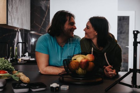 Intimate moment of a couple preparing a healthy meal together in a stylish kitchen setting.