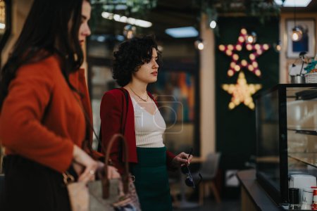Business professionals engage in a discussion near a cafe adorned with a star decoration, signifying a relaxed yet festive business atmosphere.