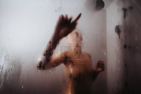 Artistic image capturing a blurred human figure behind a fogged shower glass, conveying a sense of mystery and privacy.