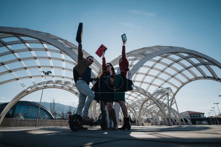 Energetic businesspeople with raised fists in a triumphant gesture, outdoors under a modern architectural structure