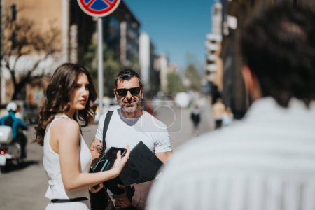 Mature and young business professionals in a casual meeting while walking in an urban setting, expressing collaboration and strategy sharing.