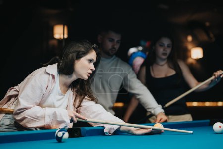 Friends bond over a competitive billiard game, showing skill with pool cues on a blue felt pool table.