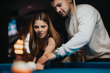 A group of young friends enjoy a fun and leisurely game of pool, showcasing teamwork and carefree recreation.