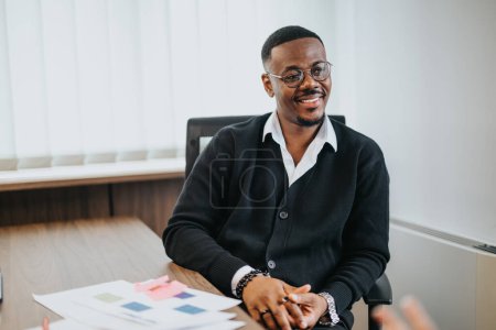 Mature businessman sporting glasses looks content and positive in a modern office setting, engaging with colleagues during a vital business discussion.