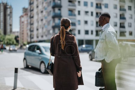 A young woman and man in casual office outfits crossing a busy street, engaged in a light conversation amidst the city hustle.