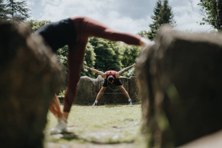 Two friends or a couple engaging in a stretching session in an urban park, showcasing a healthy, active lifestyle surrounded by nature.