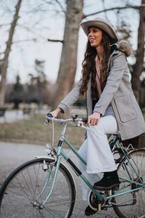 A poised business lady enjoys a peaceful moment with her classic bicycle in the serenity of an urban park.