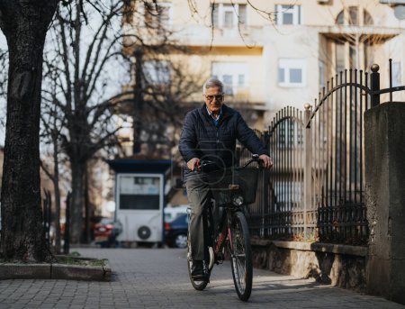An elderly man confidently riding his bicycle on a quiet city street, showcasing active lifestyle and urban commuting.