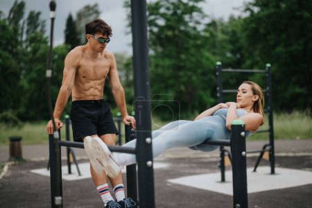 Couple performing an outdoor calisthenics workout together in a park. The image depicts fitness, strength, and teamwork in action.