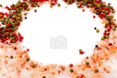 Photo for Pink salt and pepper created a icircle on a white background. The view of top. Natural pink salt with large crystals. Put in circle an object - Royalty Free Image