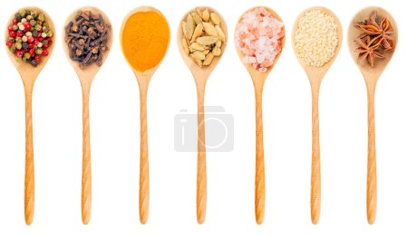 Photo for Wooden spoon with different spices isplated on a white background. The image of spoon in one style. Top of view. Seven different spices in wooden spoon. - Royalty Free Image