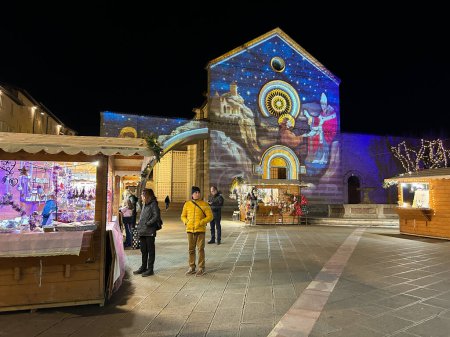 Photo for ASSISI, ITALY - DECEMBER 18, 2023: Traditional christmas market in the square of Santa Chiara Basilica of Assisi, Umbria region, Italy - Royalty Free Image
