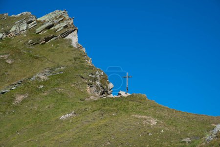 View of the summit cross of Giogo Lungo Alm in Alto Adige, Italy