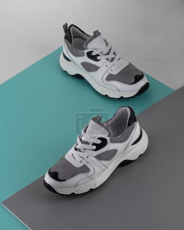 Photo for Modern street shoes stand stone on stone against a gray background - Royalty Free Image