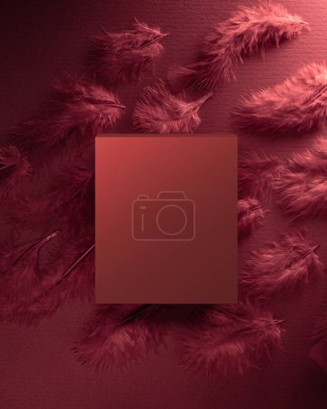 Téléchargez les photos : Boîte rouge sur un fond rouge se trouve au-dessus des plumes rouges décoratives - en image libre de droit