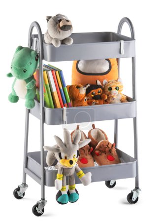 Photo for Playful and practical storage trolley on wheels, with large baskets filled with stuffed toys, books, and cozy slippers, perfect for organizing kids room, isolated on white - Royalty Free Image